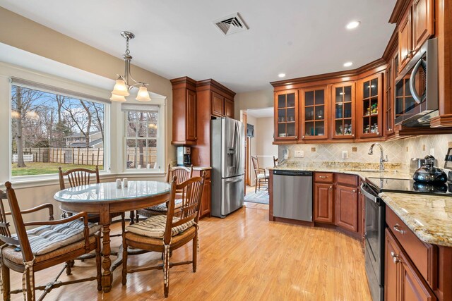 14 Hillside Ave, Saint James, NY 11780 - kitchen featuring stainless steel appliances, a sink, light wood-style floors, recessed lighting, and decorative backsplash