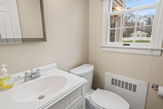 14 Hillside Ave, Saint James, NY 11780 - half bathroom with radiator, toilet, and vanity