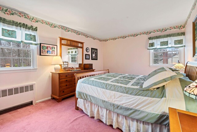 14 Hillside Ave, Saint James, NY 11780 - carpeted bedroom with radiator heating unit, multiple windows, and baseboards