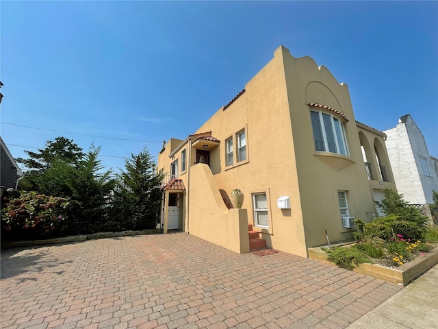 119 Mitchell Ave, Long Beach, NY 11561 - exterior space featuring a balcony, cooling unit, and stucco siding