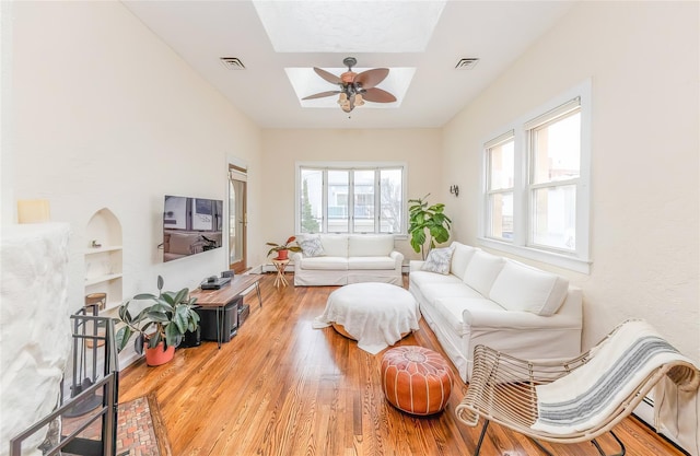 119 Mitchell Ave, Long Beach, NY 11561 - living room with a ceiling fan, visible vents, wood finished floors, and a skylight