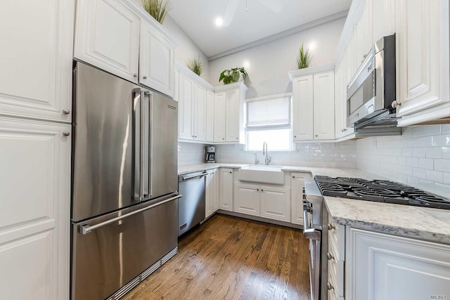 119 Mitchell Ave, Long Beach, NY 11561 - kitchen with a sink, tasteful backsplash, light stone counters, white cabinets, and high end appliances