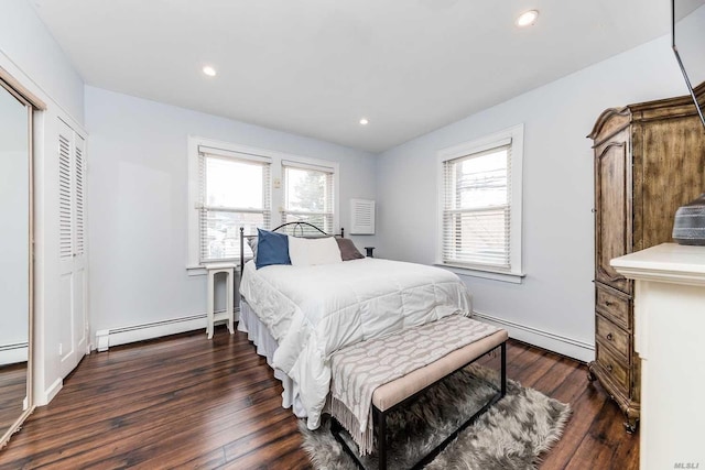 119 Mitchell Ave, Long Beach, NY 11561 - bedroom featuring a baseboard heating unit, multiple windows, and dark wood-type flooring