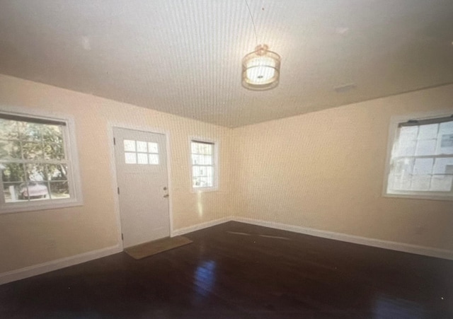 entrance foyer featuring dark wood-style floors and baseboards