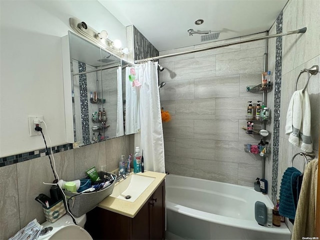133-25 Blossom Ave, Flushing, NY 11355 - bathroom featuring vanity, shower / bath combination with curtain, and tile walls