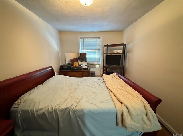 133-25 Blossom Ave, Flushing, NY 11355 - bedroom featuring baseboards and radiator