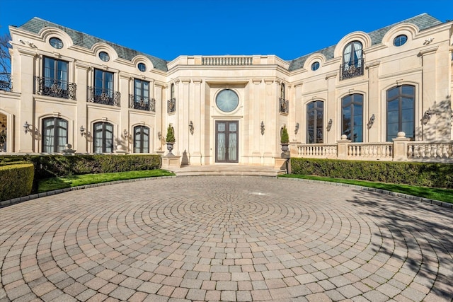 186 Kings Point Rd, Great Neck, NY 11024 - french country home featuring french doors, curved driveway, and stone siding