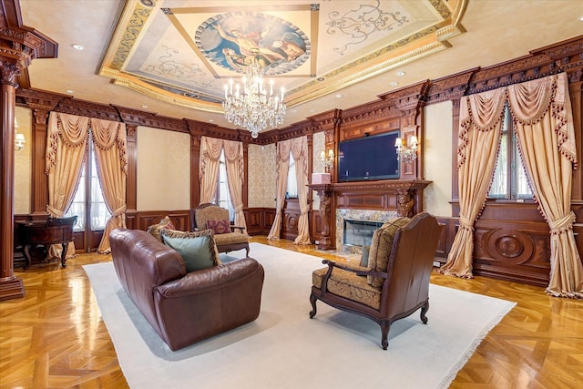 186 Kings Point Rd, Great Neck, NY 11024 - living room featuring a raised ceiling, ornamental molding, a chandelier, ornate columns, and a high end fireplace