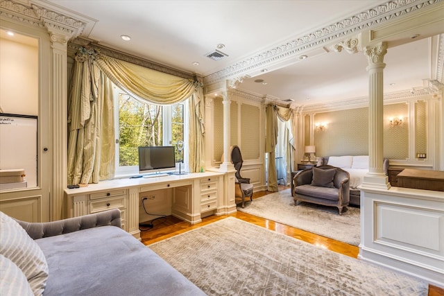 186 Kings Point Rd, Great Neck, NY 11024 - bedroom with ornate columns, ornamental molding, a decorative wall, and wood finished floors