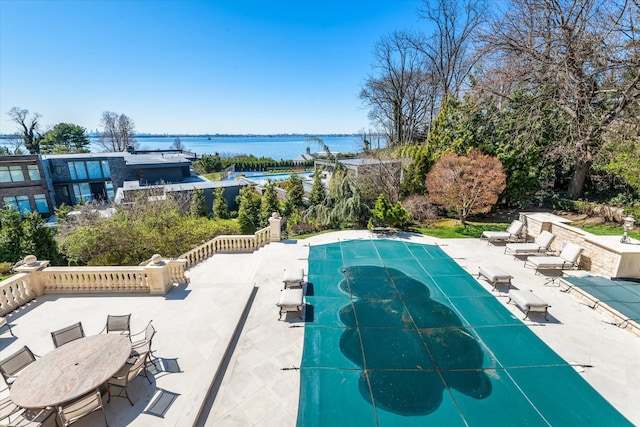 186 Kings Point Rd, Great Neck, NY 11024 - view of pool with a patio area, a water view, and a covered pool