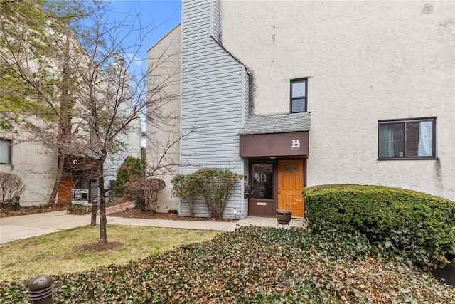 view of front of property with stucco siding and a chimney