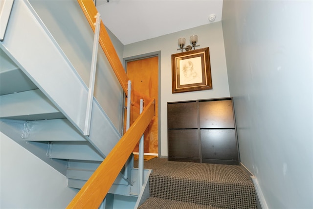 stairs with carpet and baseboards