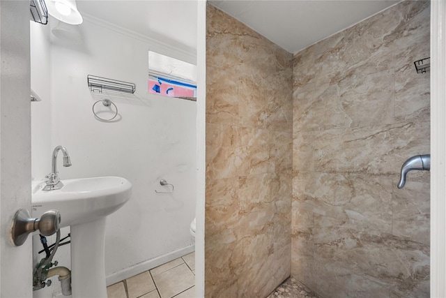 bathroom with tile patterned flooring, toilet, and baseboards