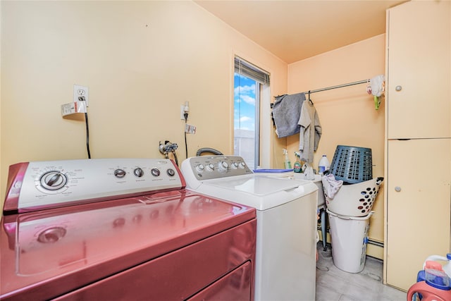 clothes washing area featuring independent washer and dryer, laundry area, and baseboard heating