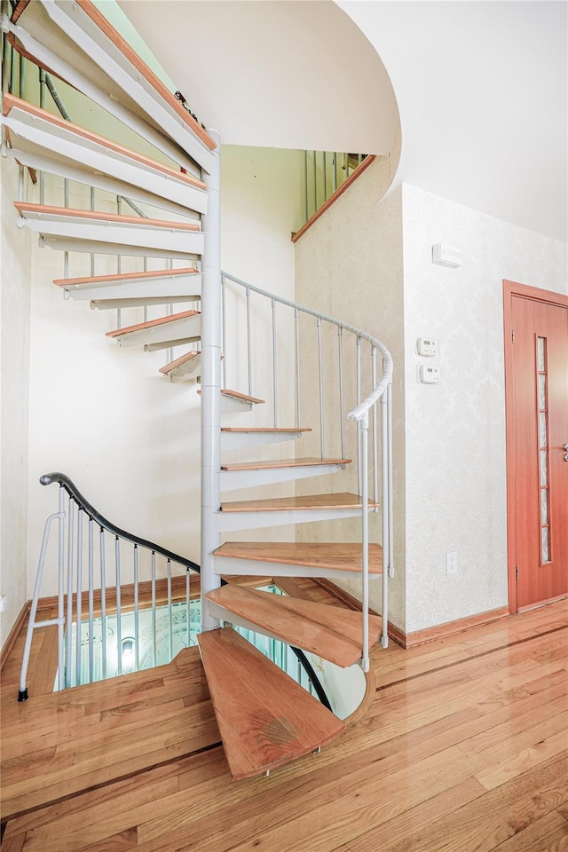 stairway with wood finished floors