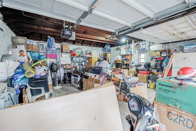 garage featuring a garage door opener and freestanding refrigerator