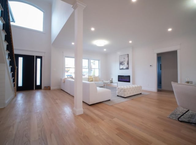 2566 Aster Pl N, Westbury, NY 11590 - foyer entrance featuring light wood-style floors, recessed lighting, and a fireplace