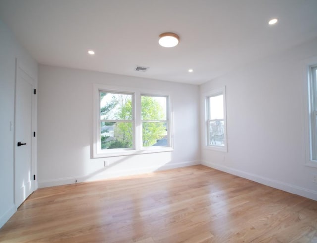2566 Aster Pl N, Westbury, NY 11590 - empty room with light wood-style flooring and recessed lighting