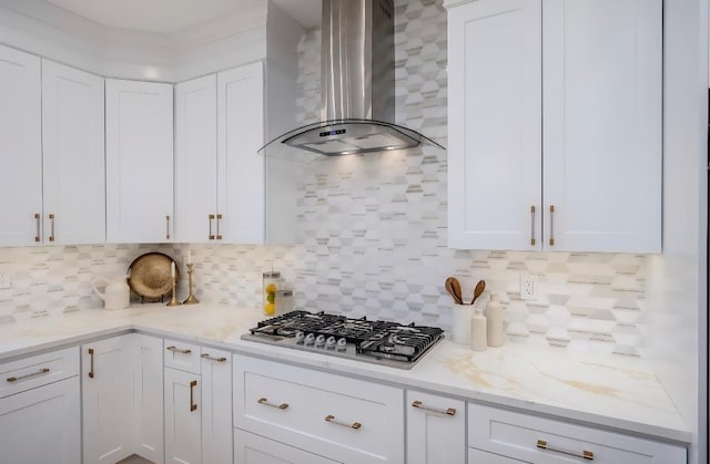 2566 Aster Pl N, Westbury, NY 11590 - kitchen featuring wall chimney range hood, stainless steel gas cooktop, white cabinetry, and tasteful backsplash