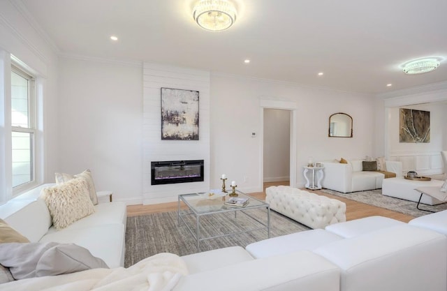 2566 Aster Pl N, Westbury, NY 11590 - living area featuring ornamental molding, a large fireplace, light wood-style flooring, and recessed lighting