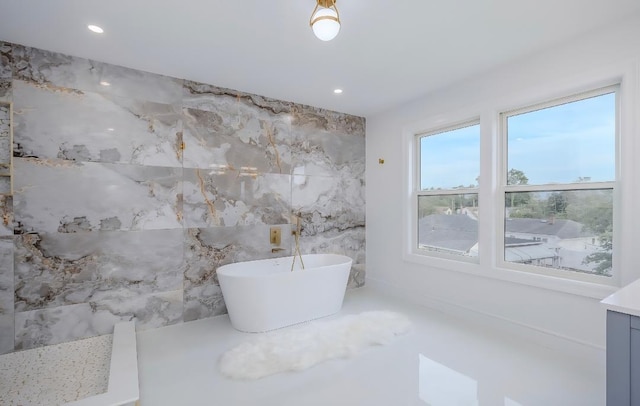 2566 Aster Pl N, Westbury, NY 11590 - bathroom with a soaking tub, tile walls, recessed lighting, and vanity