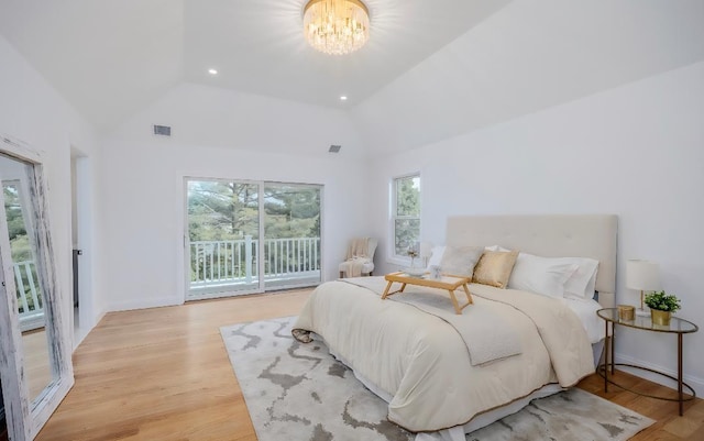 2566 Aster Pl N, Westbury, NY 11590 - bedroom with lofted ceiling, access to outside, a chandelier, and light wood-style floors