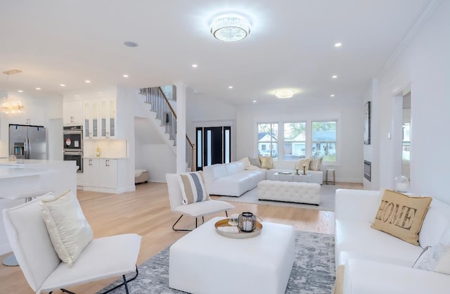 2566 Aster Pl N, Westbury, NY 11590 - living room featuring light wood finished floors, stairway, and recessed lighting