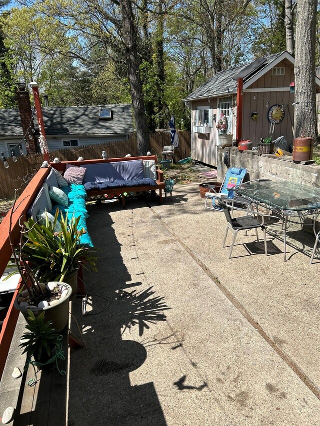 25 Tamarack Rd, Rocky Point, NY 11778 - view of patio / terrace featuring an outdoor structure, a fenced backyard, and a storage unit