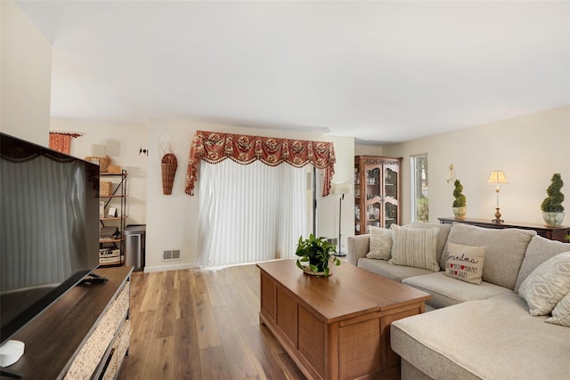living room featuring wood finished floors and visible vents