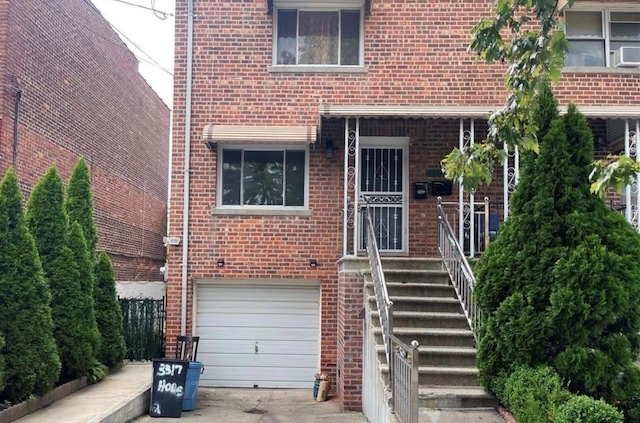 3317 Hone Ave, Bronx, NY 10469 - view of front of house with a garage, brick siding, and concrete driveway