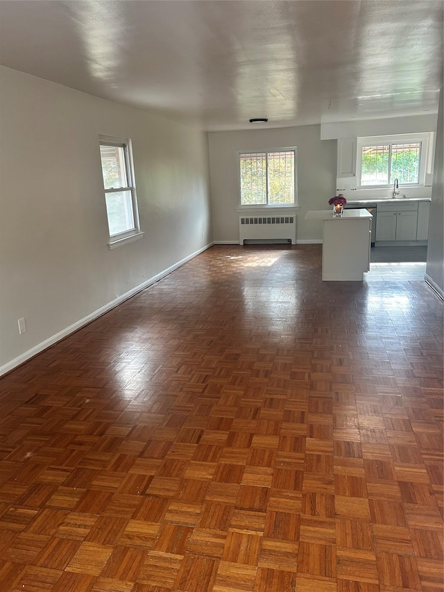 3317 Hone Ave, Bronx, NY 10469 - unfurnished living room with radiator and baseboards
