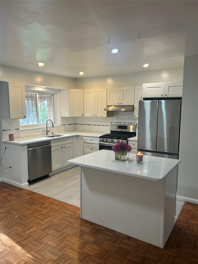 3317 Hone Ave, Bronx, NY 10469 - kitchen with appliances with stainless steel finishes, under cabinet range hood, light countertops, a center island, and recessed lighting