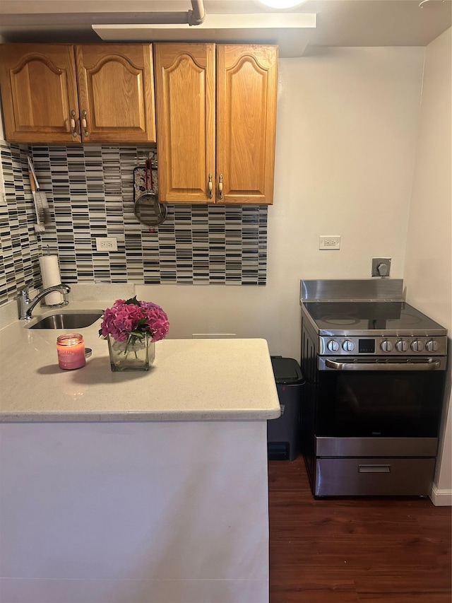 3317 Hone Ave, Bronx, NY 10469 - kitchen featuring stainless steel range with electric cooktop, light countertops, dark wood-type flooring, and tasteful backsplash