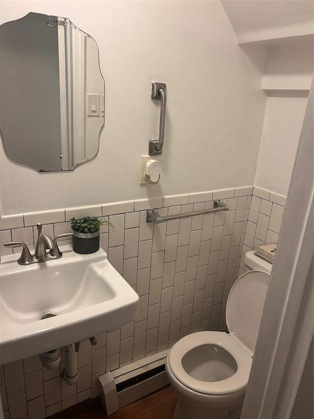 3317 Hone Ave, Bronx, NY 10469 - bathroom featuring tile walls, a baseboard radiator, and a wainscoted wall