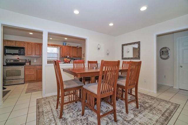 dining space featuring light tile patterned floors and recessed lighting