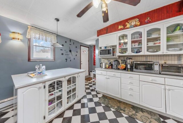 11812 Francis Lewis Blvd, Cambria Heights, NY 11411 - kitchen with a baseboard radiator, a ceiling fan, dark floors, and a toaster