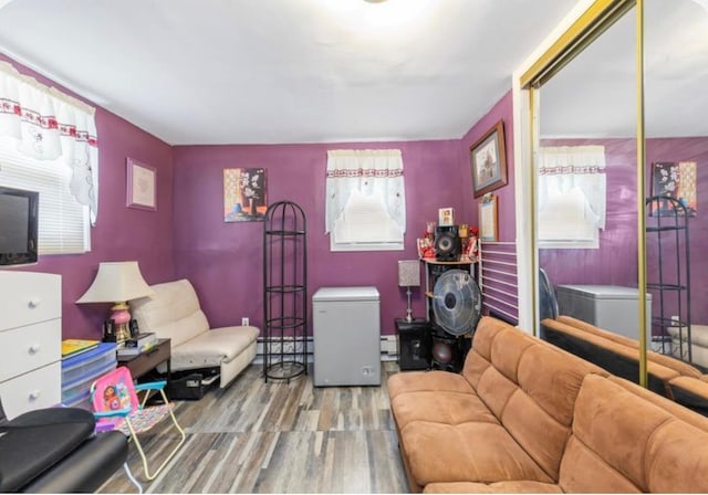 11812 Francis Lewis Blvd, Cambria Heights, NY 11411 - living room featuring a baseboard heating unit and wood finished floors