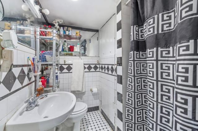 11812 Francis Lewis Blvd, Cambria Heights, NY 11411 - bathroom featuring tile walls, toilet, tile patterned floors, and a sink