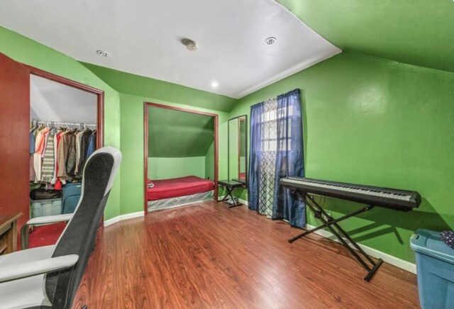 11812 Francis Lewis Blvd, Cambria Heights, NY 11411 - bedroom with baseboards, lofted ceiling, wood finished floors, and a spacious closet