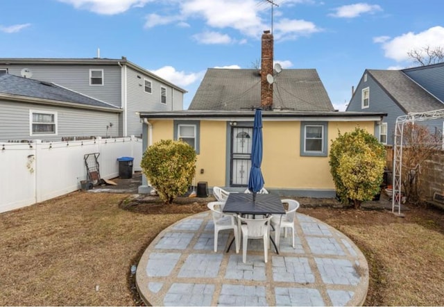 11812 Francis Lewis Blvd, Cambria Heights, NY 11411 - rear view of property featuring a patio area, stucco siding, a chimney, and fence