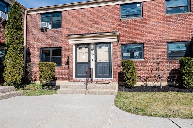 view of exterior entry with brick siding