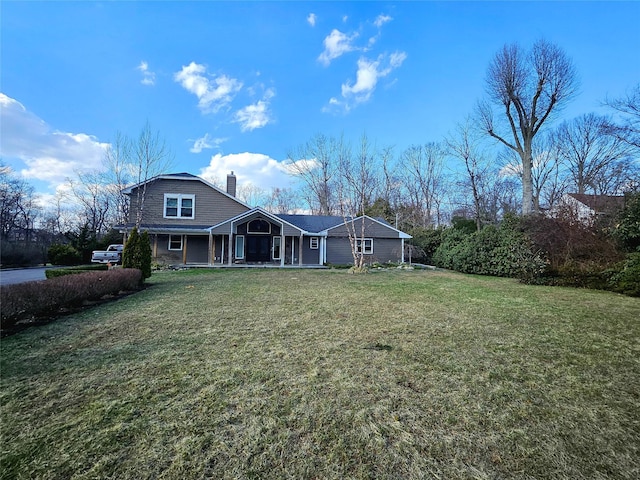 7 Raynham Rd, Glen Cove, NY 11542 - back of property with a chimney, a lawn, and covered porch
