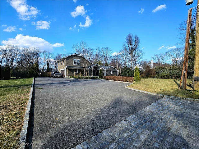 7 Raynham Rd, Glen Cove, NY 11542 - view of asphalt driveway featuring curbs