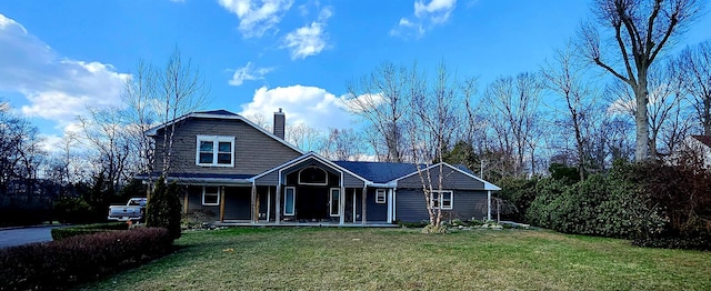 7 Raynham Rd, Glen Cove, NY 11542 - view of front facade with a chimney, a front lawn, and covered porch