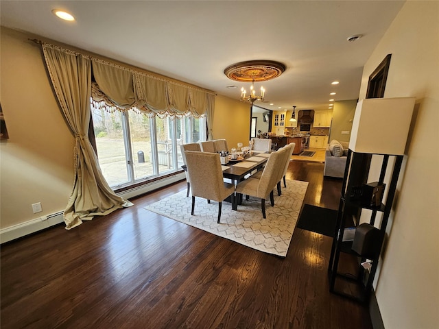 7 Raynham Rd, Glen Cove, NY 11542 - dining room with a baseboard heating unit, a chandelier, dark wood-style floors, and recessed lighting