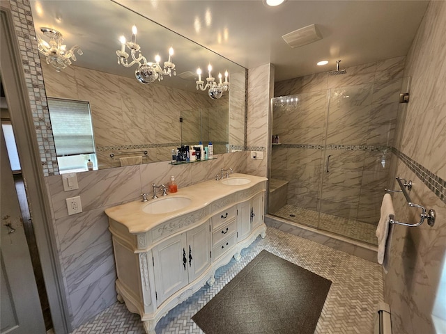 7 Raynham Rd, Glen Cove, NY 11542 - bathroom with tile walls, a shower stall, double vanity, recessed lighting, and a chandelier