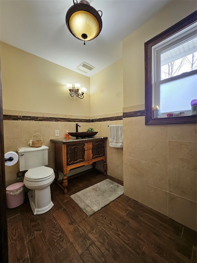 7 Raynham Rd, Glen Cove, NY 11542 - bathroom featuring tile walls, a wainscoted wall, wood finished floors, toilet, and vanity