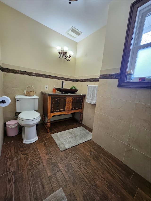 7 Raynham Rd, Glen Cove, NY 11542 - bathroom featuring tile walls, a wainscoted wall, wood finished floors, toilet, and vanity