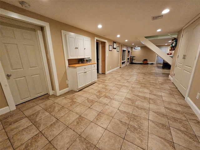 7 Raynham Rd, Glen Cove, NY 11542 - kitchen featuring white cabinets, recessed lighting, baseboards, open floor plan, and light countertops