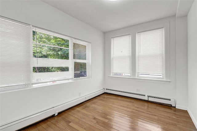 48-35 Clearview Expy, Bayside, NY 11364 - unfurnished room with a baseboard heating unit and light wood-style floors